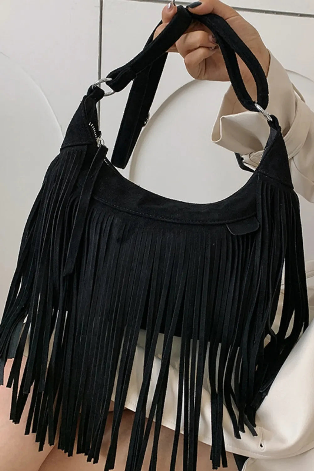 Suede Fringe Adjustable Strap Shoulder Bag with black fringes, showcasing a stylish design and adjustable straps.