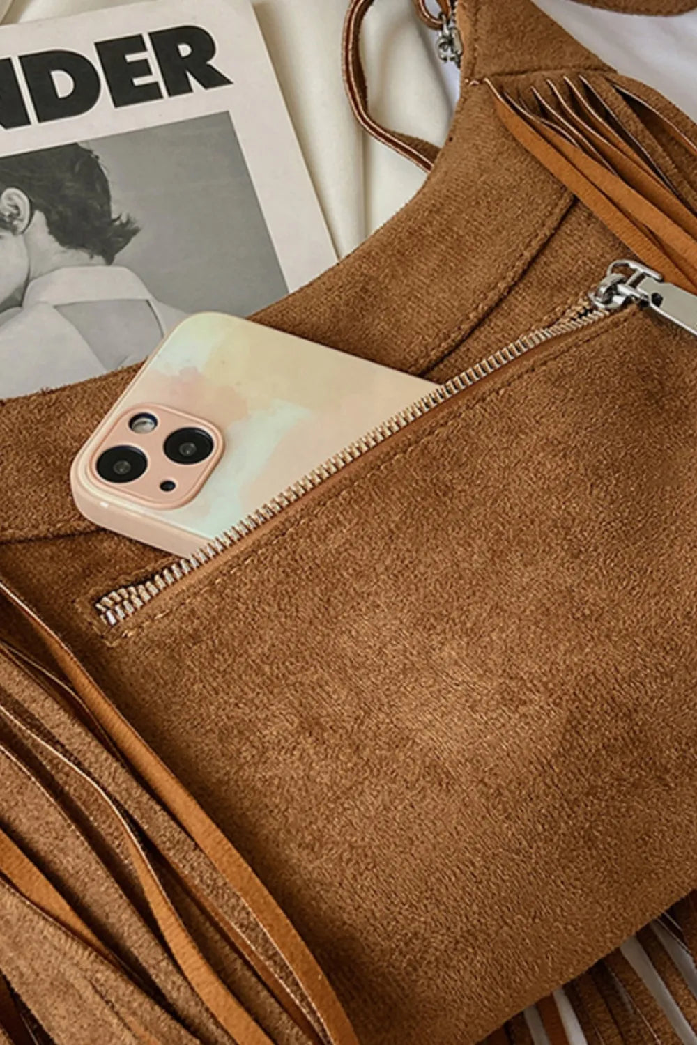 Close-up of Suede Fringe Adjustable Strap Shoulder Bag showcasing its pocket with phone and fringe details.