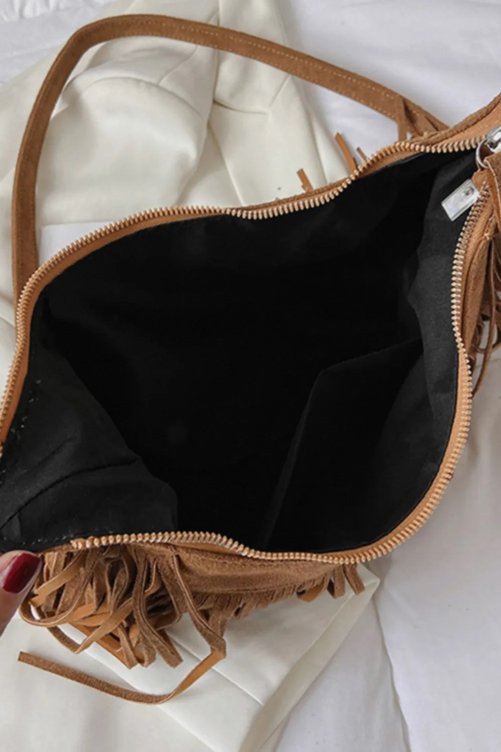 Interior view of Suede Fringe Adjustable Strap Shoulder Bag showcasing a spacious black lining.