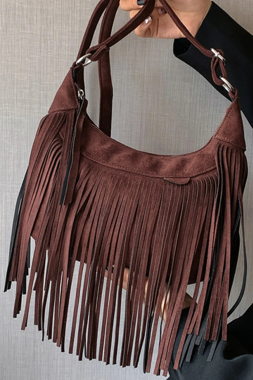 Suede Fringe Adjustable Strap Shoulder Bag with brown fringe design held by a model against a neutral background.